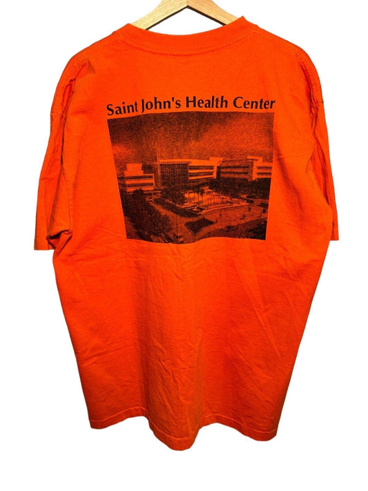 Vintage 90s Saint John’s Health Center T-Shirt Size XL Single Stitched Orange 